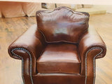 Spacious Leather Chair With Rounded Arms And Curved Back.