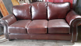 Three Seat Leather Sofa With Rounded Arms And Curved Sofa Back.